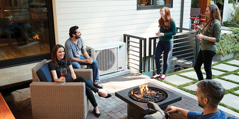 Friends hanging outdoors near an air conditioner